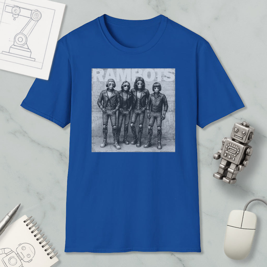 a blue t-shirt with a black and white photograph of four people, likely representing the members of a band, along with a computer mouse and other office supplies.