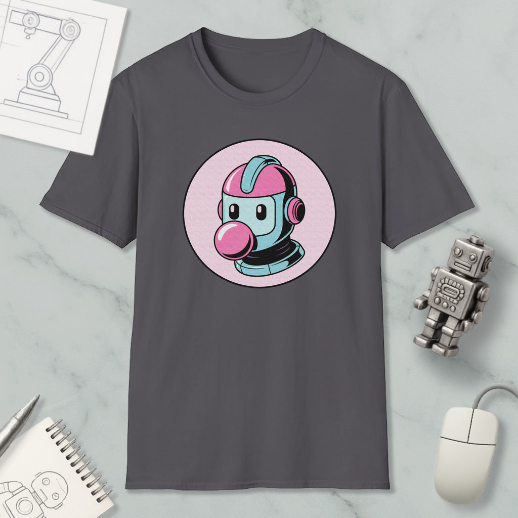 a gray t-shirt with a colorful graphic of a robot or character wearing a pink helmet, along with a computer mouse, a notebook, and a small robot figurine.