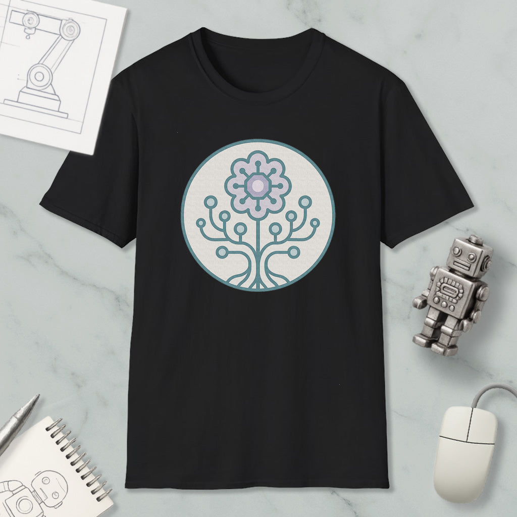 a black t-shirt with a graphic design of a flower and a tree on it, along with a computer mouse, a notebook, and a robot figurine.