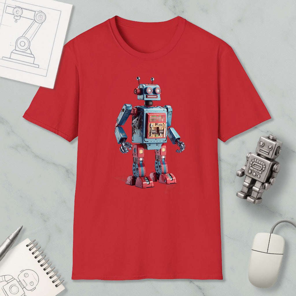 a red t-shirt with a robot design, along with a computer mouse, a notebook, and a pen on a marble surface.
