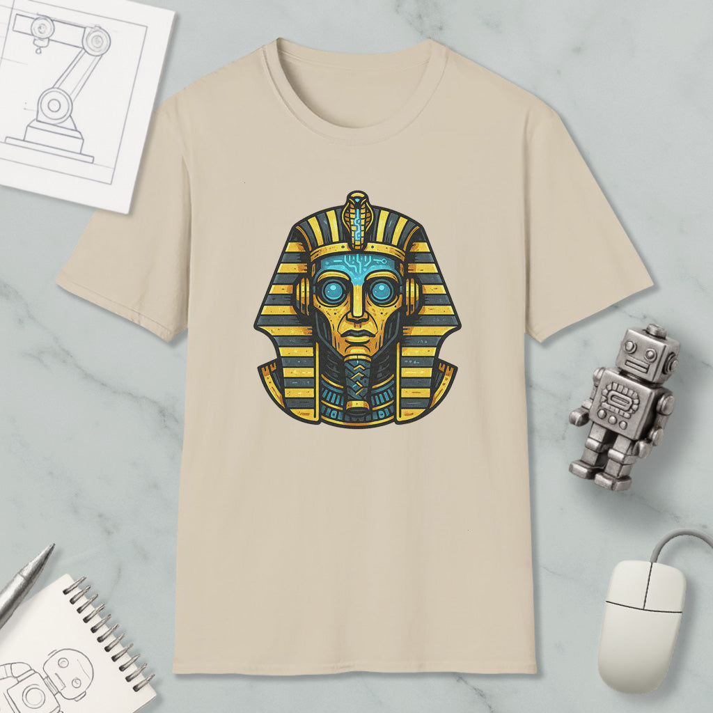 a beige t-shirt with a graphic design of an Egyptian pharaoh's head, surrounded by various objects such as a computer mouse, a notebook, and a robot.