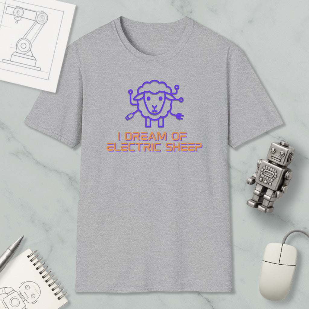 a gray t-shirt with a cartoon sheep design and text, along with various objects such as a mouse, a robot, and a notebook.