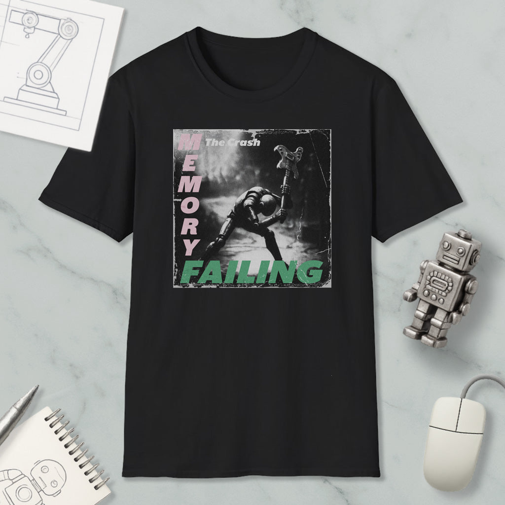 a black t-shirt with a graphic design depicting a person in a dark, moody setting. The text on the t-shirt reads "The Crash Memory Failing", and there is a small robot figure next to the t-shirt.