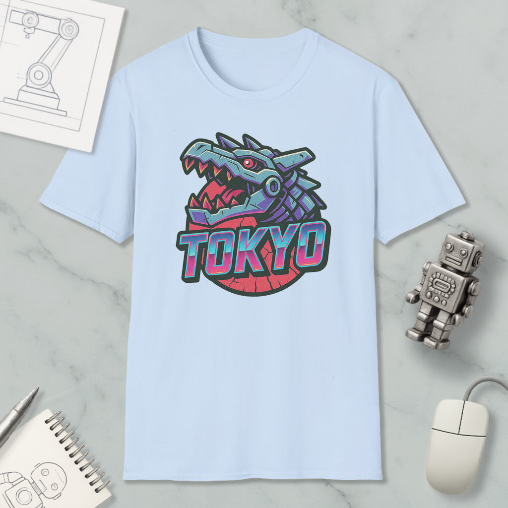 a light blue t-shirt with a graphic design of a dragon or serpent, along with the word "TOKYO" written below it. The t-shirt is placed on a marble surface, surrounded by various objects such as a computer mouse, a notebook, and a small robot.