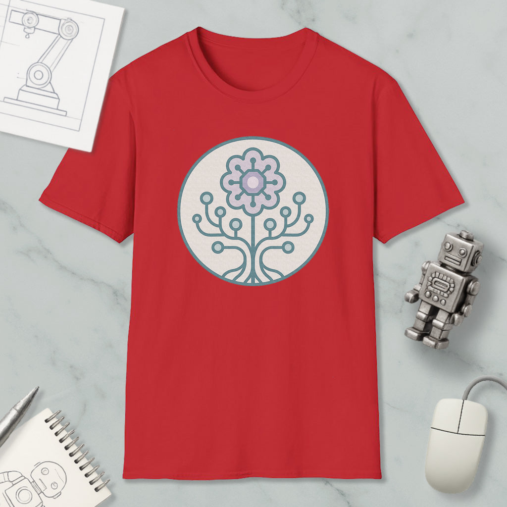 a red t-shirt with a graphic design of a flower and a tree, along with a computer mouse, a notebook, and a robot figurine.