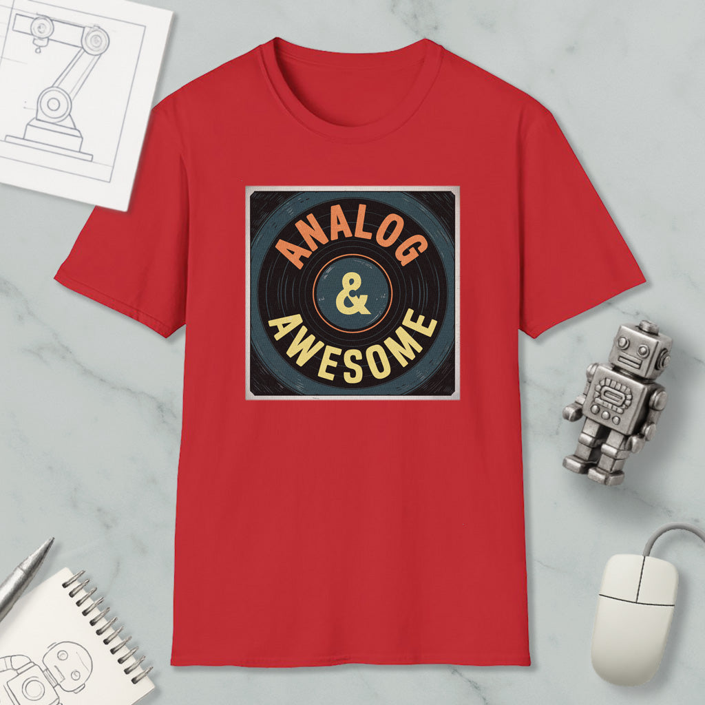 a red t-shirt with a graphic design that says "ANALOG & AWESOME" on it, along with a computer mouse and a robot figurine.