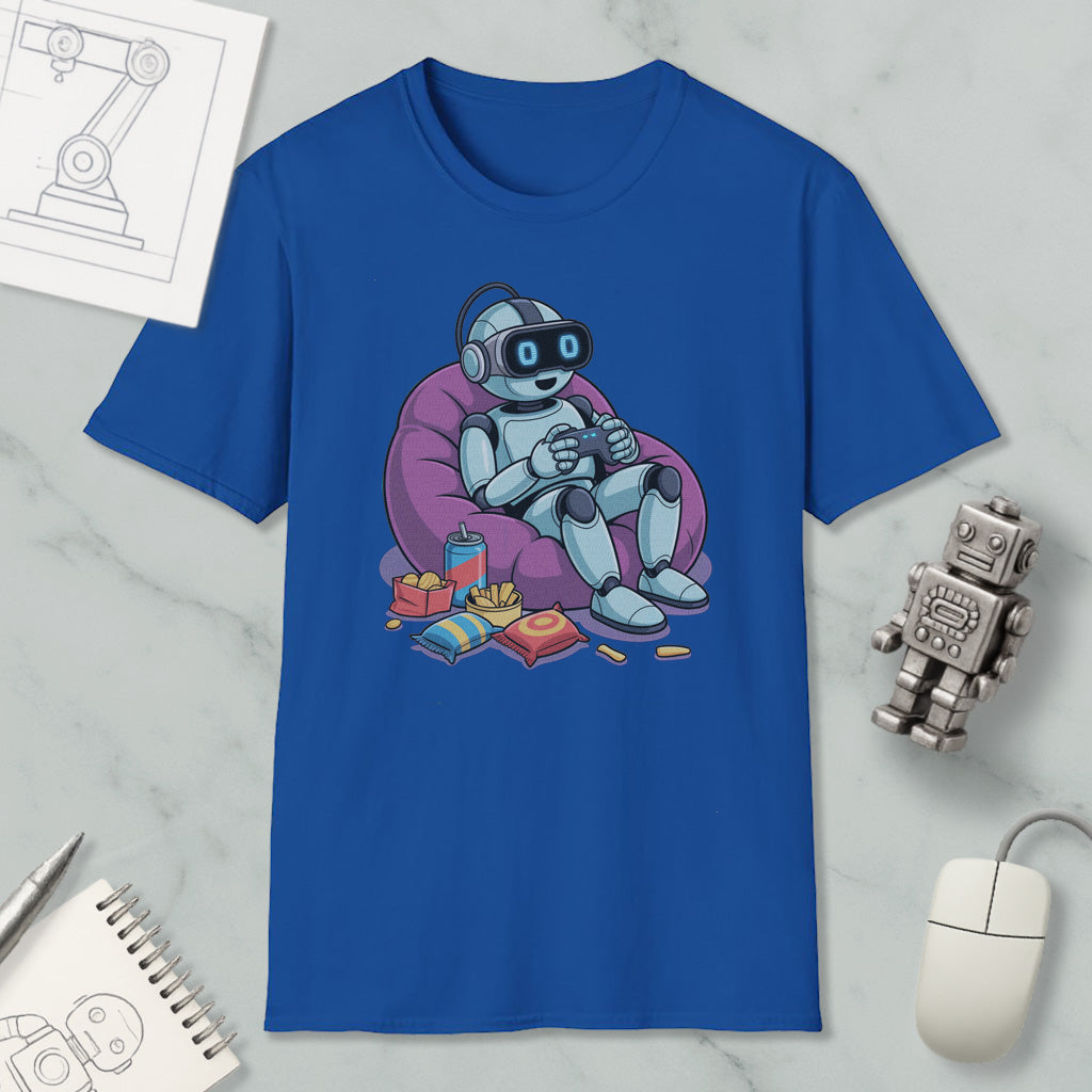 A blue t-shirt with a cartoon robot sitting in a bean bag chair, holding a remote control, surrounded by various objects such as a computer mouse, a notebook, and a toy robot.