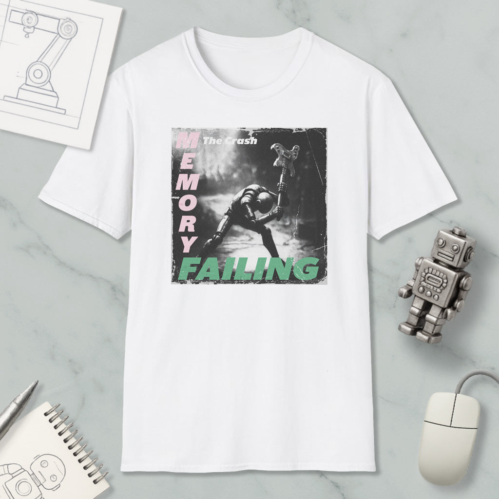a white t-shirt with a graphic design depicting a person in a dark, moody setting, along with the text "The Crash" and "Memory Failing". The t-shirt is displayed on a marble surface, surrounded by various objects such as a computer mouse, a robot, and a notebook.