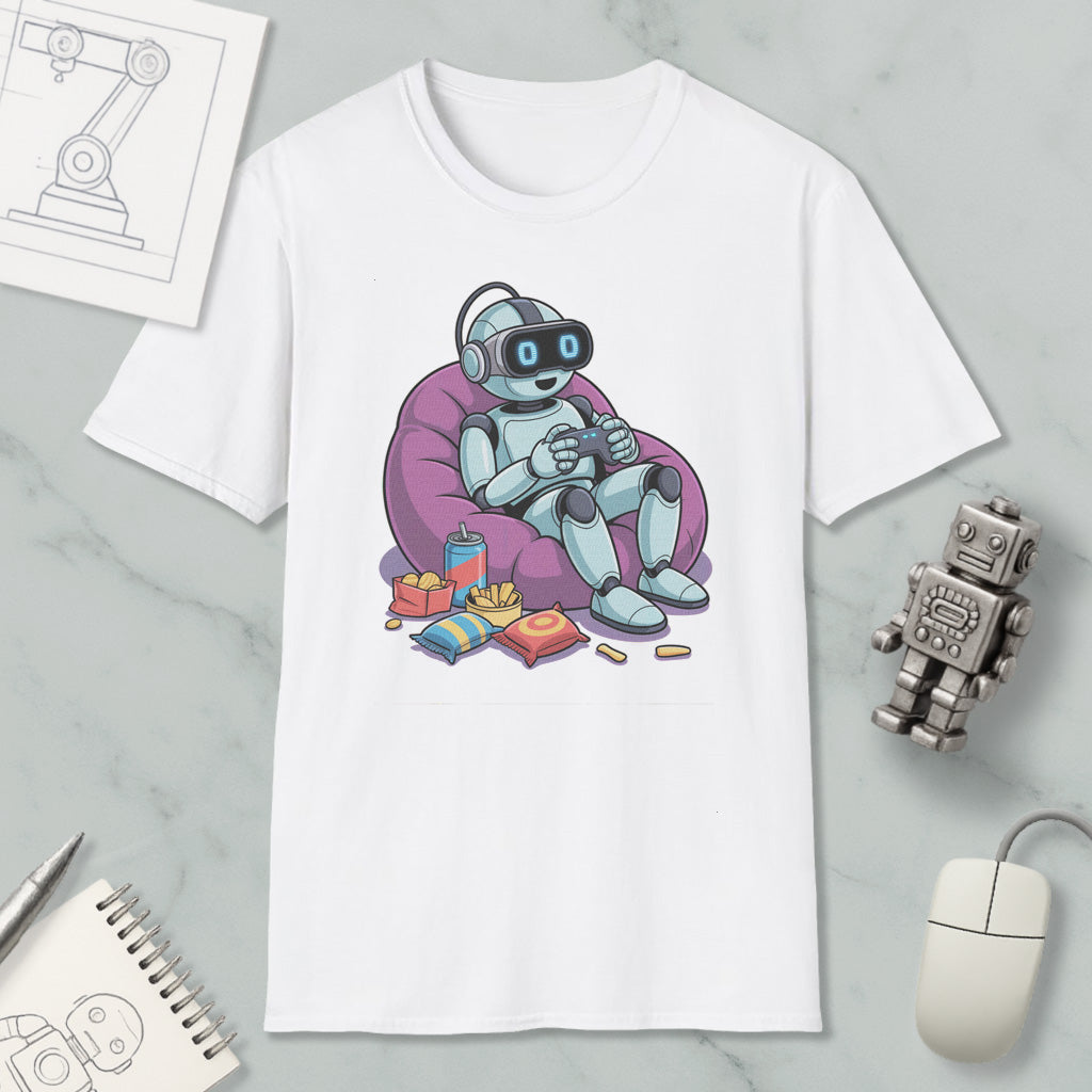 A white t-shirt with a cartoon robot sitting in a bean bag chair, holding a remote control, surrounded by snacks and a toy robot.