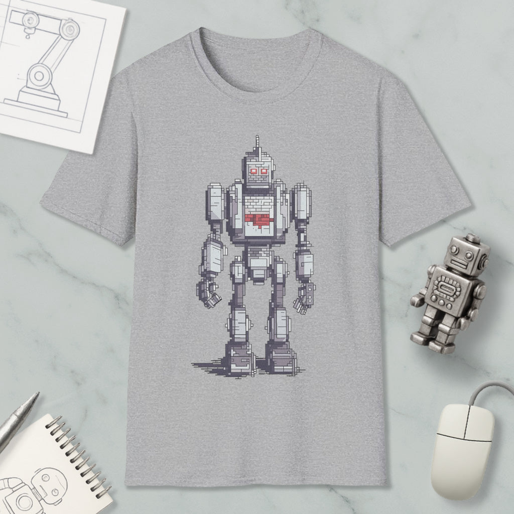 a gray t-shirt with a pixelated robot design, along with various objects such as a computer mouse, a notebook, and a pen.