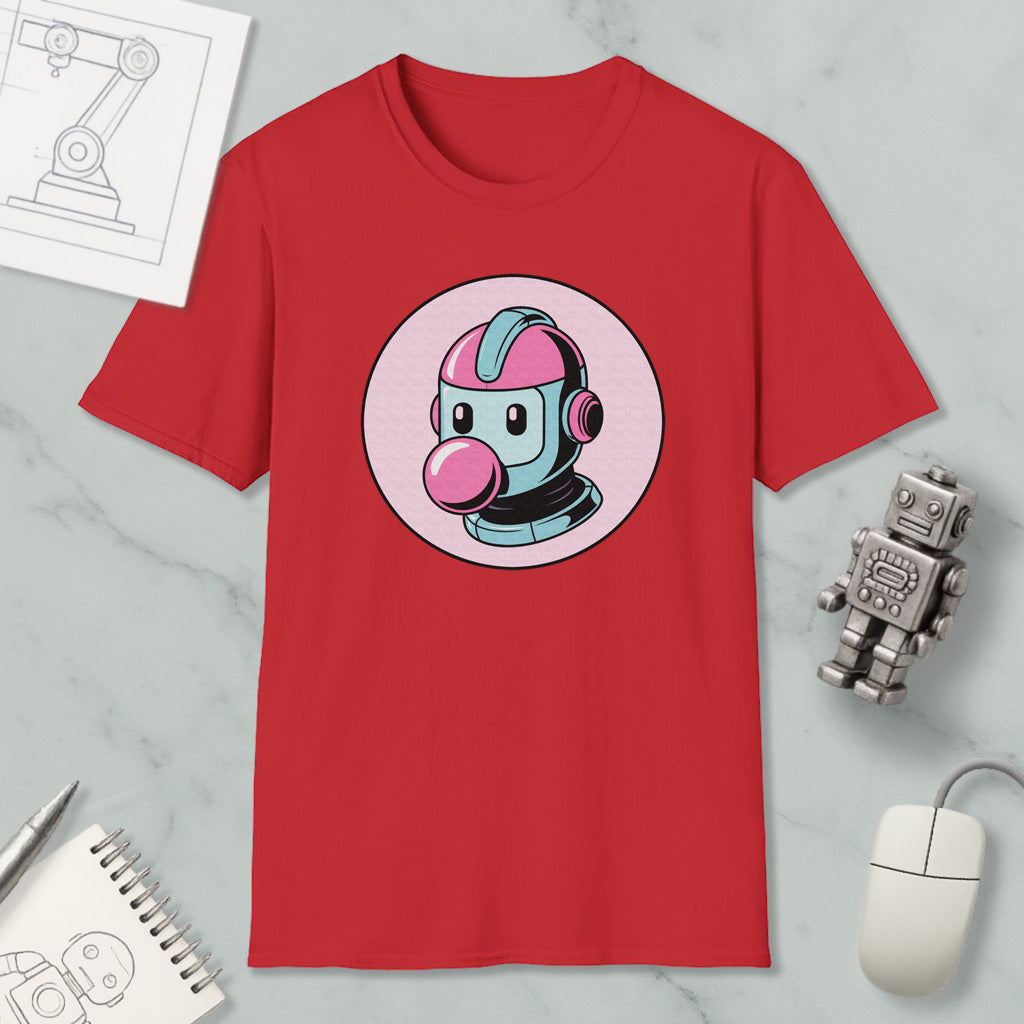 a red t-shirt with a cartoon robot graphic, along with a computer mouse, a notebook, and a pen on a marble surface.