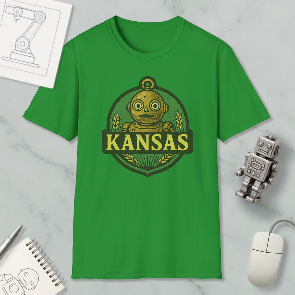 a green t-shirt with a graphic of a robot and the word "KANSAS" printed on it, along with a computer mouse and a notebook.