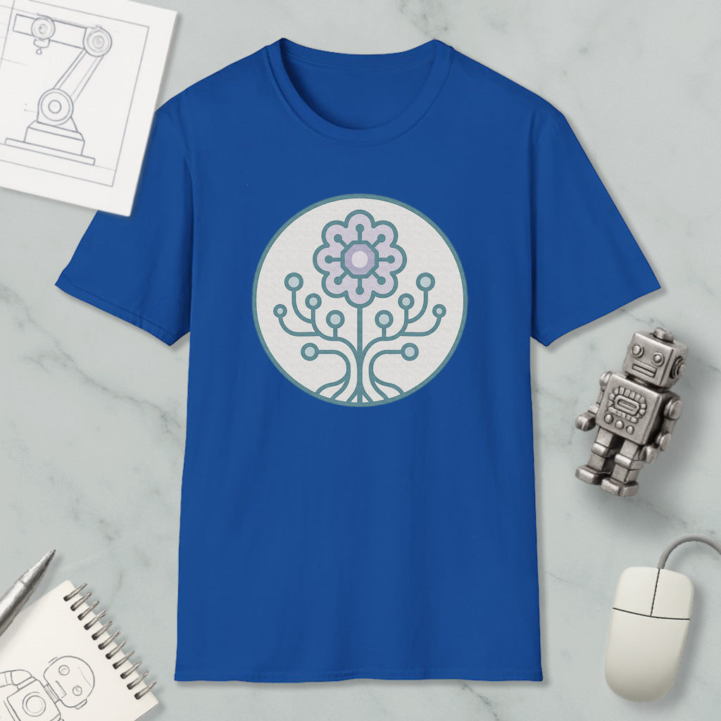 a blue t-shirt with a graphic design of a flower and a tree, along with a computer mouse, a notebook, and a robot figurine.