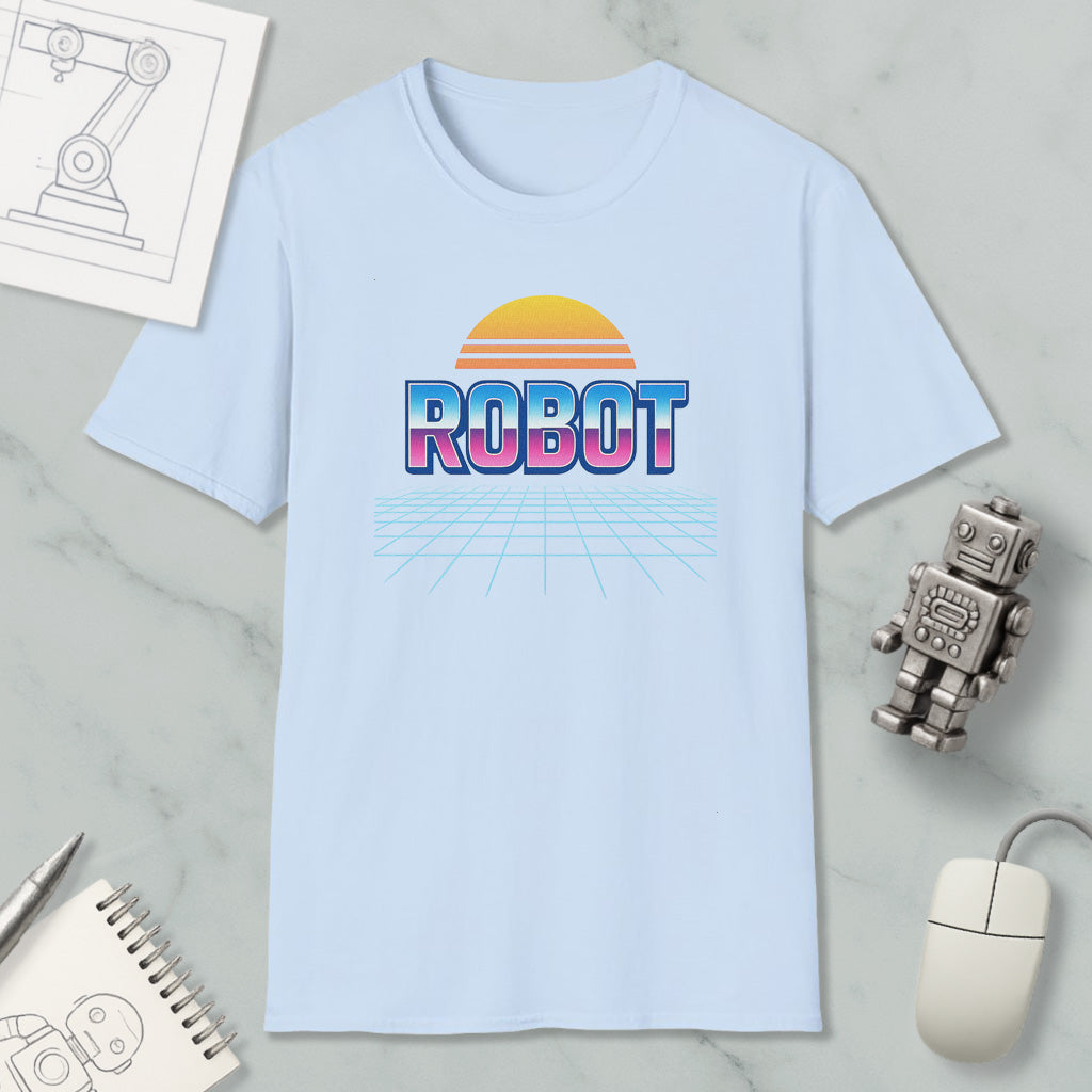 a light blue t-shirt with a graphic design of a robot and a sunset, along with various objects such as a computer mouse, a notebook, and a pen.