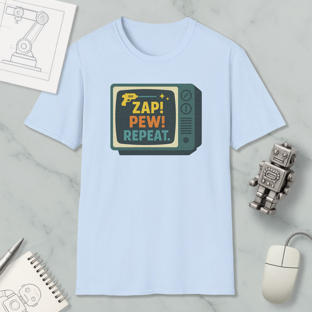 A light blue t-shirt with a graphic design featuring a television set and the text "ZAP! PEW! REPEAT."