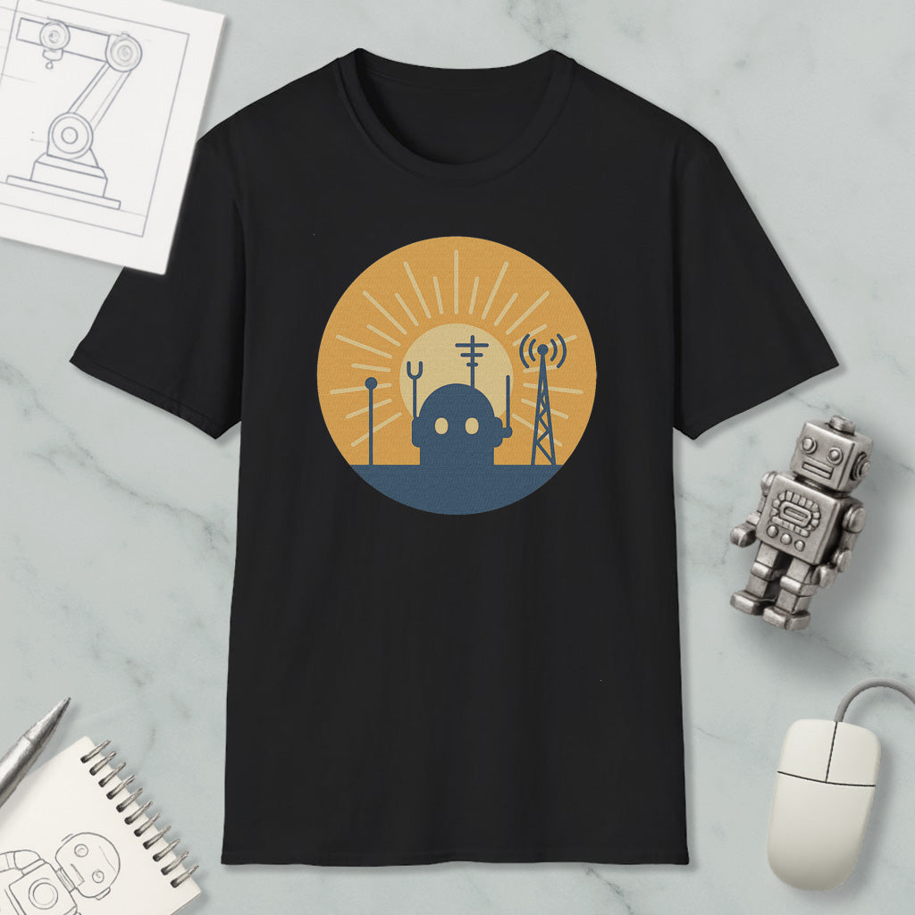 a black t-shirt with a graphic design depicting a robot and various technological elements, such as a tower and antenna, set against a sun-like background.