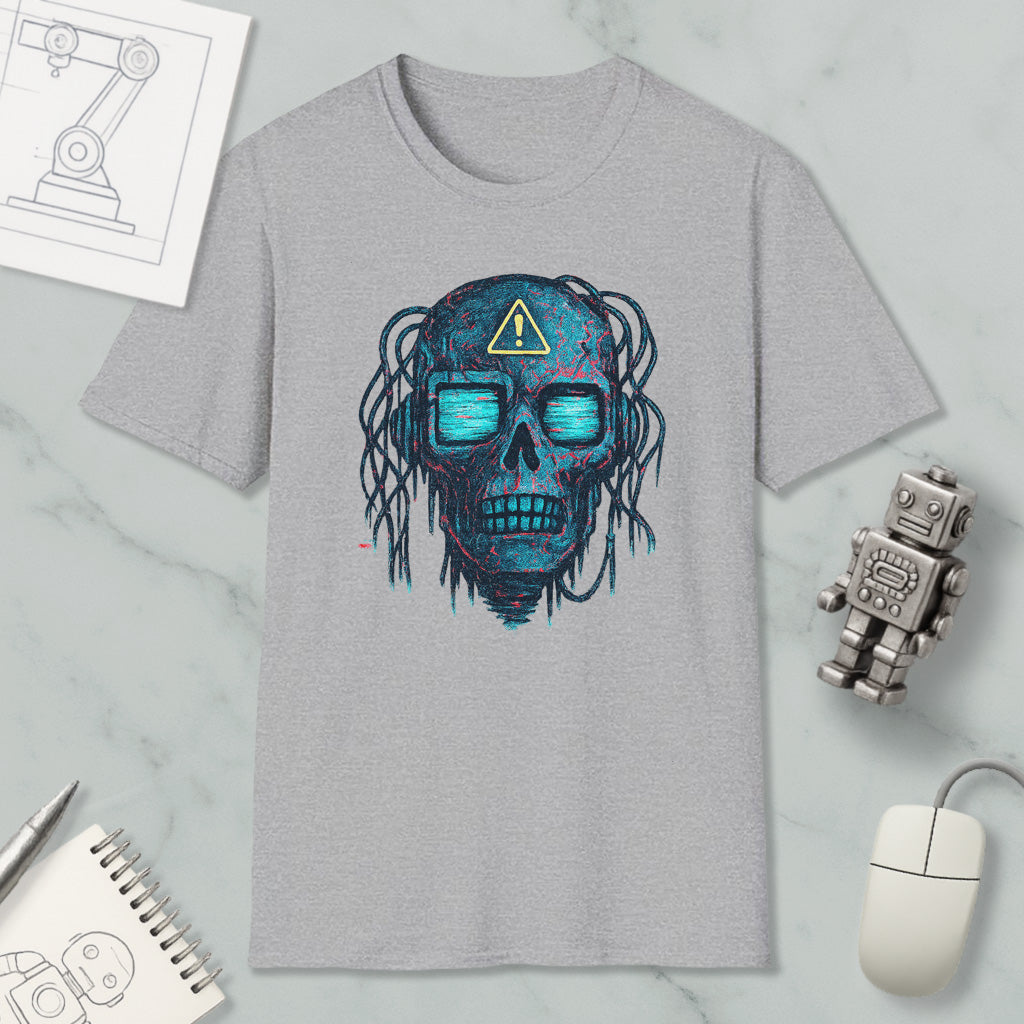 a gray t-shirt with a skull design, a computer mouse, a notebook, and a robot figure on a marble surface.