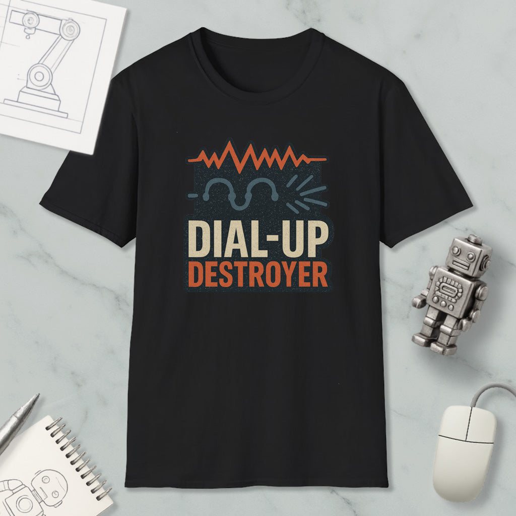 a black t-shirt with a graphic design that says "DIAL-UP DESTROYER" in orange and white text. The t-shirt is placed on a marble surface, along with a small robot toy and a computer mouse.