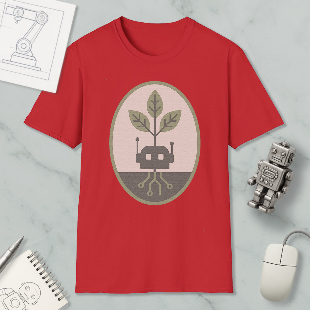 a red t-shirt with a graphic design, a small robot, a computer mouse, and a notebook on a marble surface.