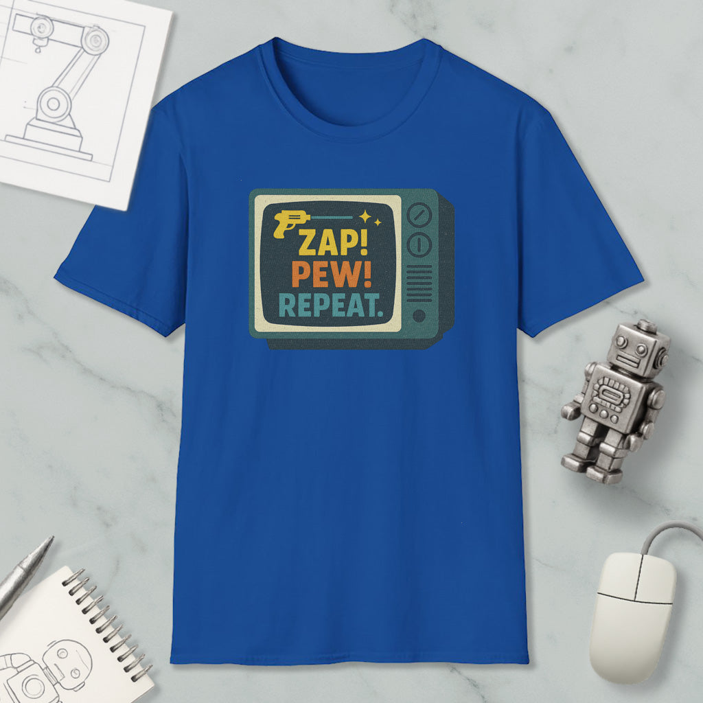 a blue t-shirt with a graphic design, a computer mouse, a notebook, and a small robot on a marble surface.
