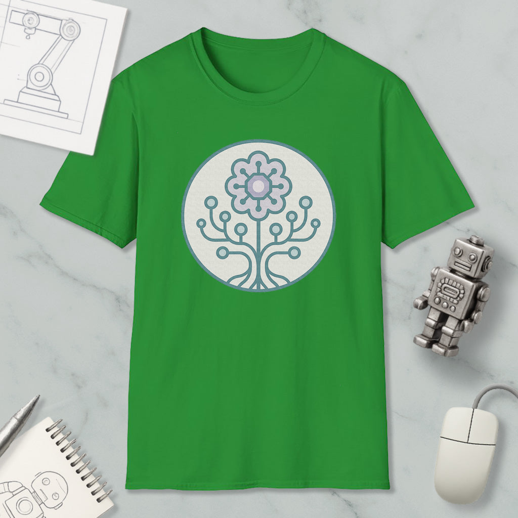 a green t-shirt with a graphic design of a flower and a tree on it, along with a computer mouse, a notebook, and a robot figurine.