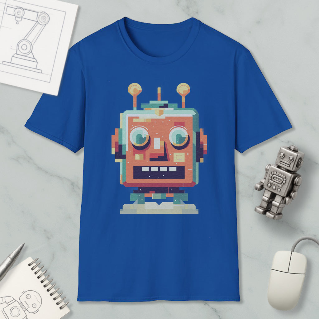a blue t-shirt with a colorful robot graphic, along with a computer mouse, a notepad, and a small robot figurine.