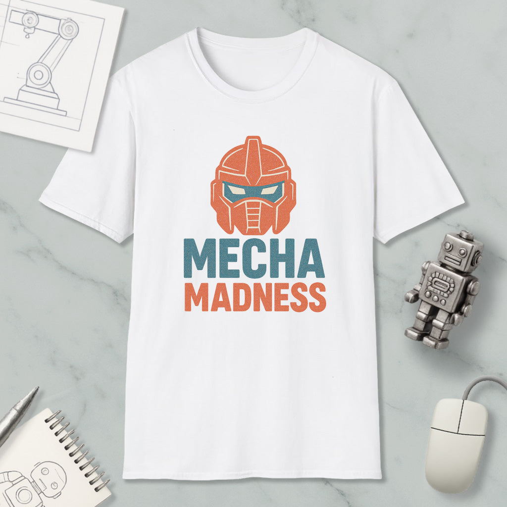 a white t-shirt with a graphic design of a robot head and the text "MECHA MADNESS" printed on it, along with a computer mouse and a notebook.
