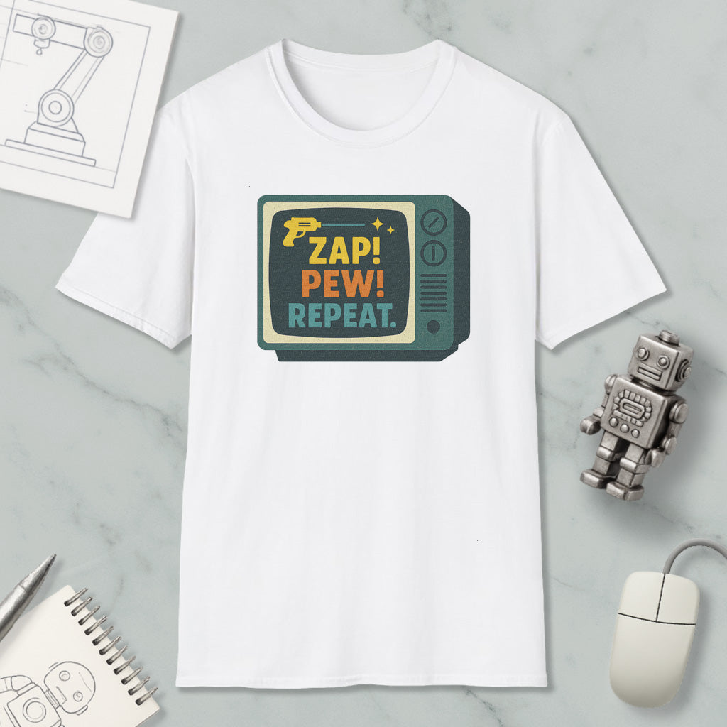a white t-shirt with a colorful graphic design, a computer mouse, a pen, a notebook, and a small robot on a marble surface.