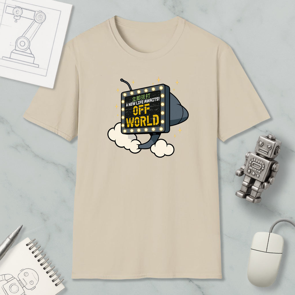 a beige t-shirt with a graphic design, a small robot, a mouse, and some other items on a marble surface.