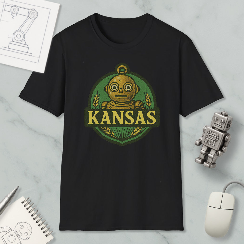 a black t-shirt with a graphic design of a robot and the word "KANSAS" printed on it, along with a small robot figurine and a computer mouse.