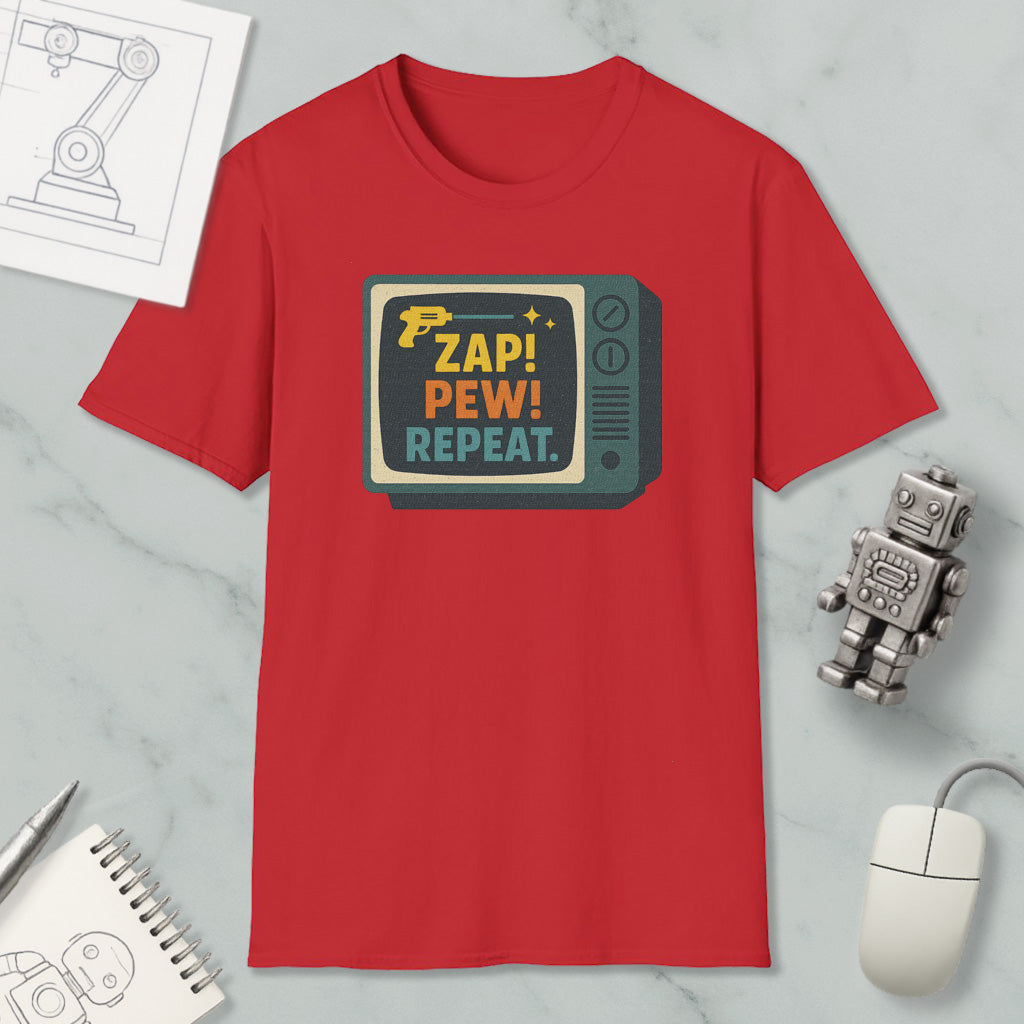 a red t-shirt with a graphic design, a computer mouse, a pen, a notebook, and a small robot on a marble surface.