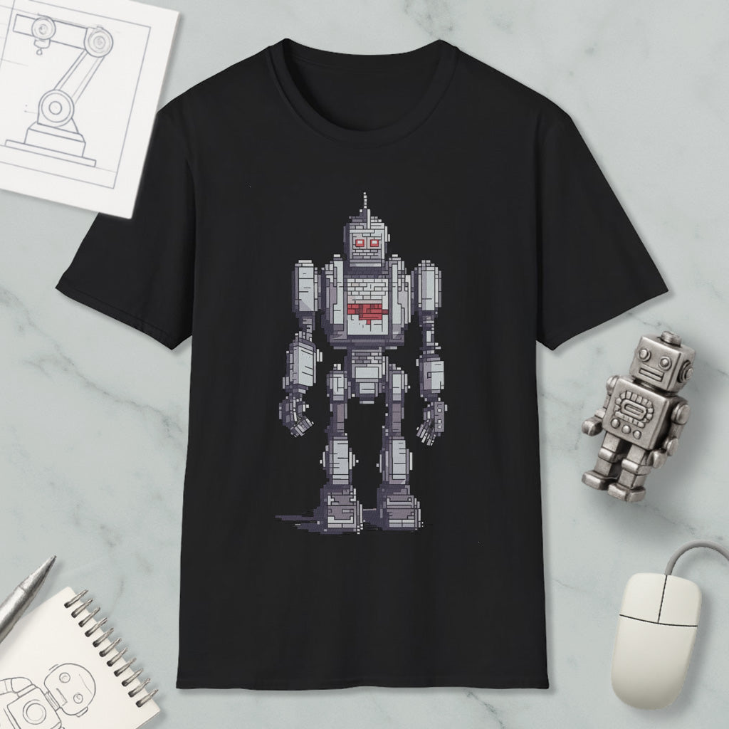 a black t-shirt with a pixelated robot design, along with a computer mouse, a notepad, and a pen on a marble surface.