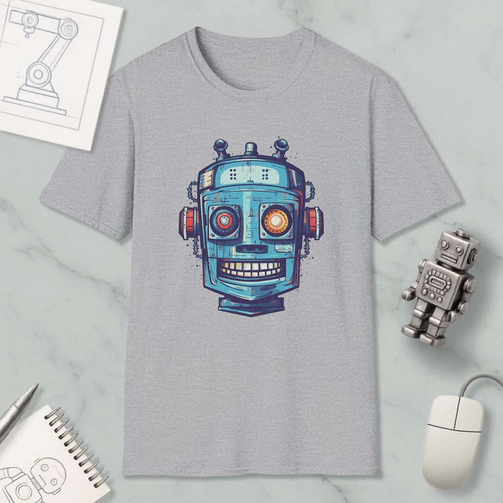 a gray t-shirt with a colorful robot design, along with various objects such as a computer mouse, a notebook, and a pen.