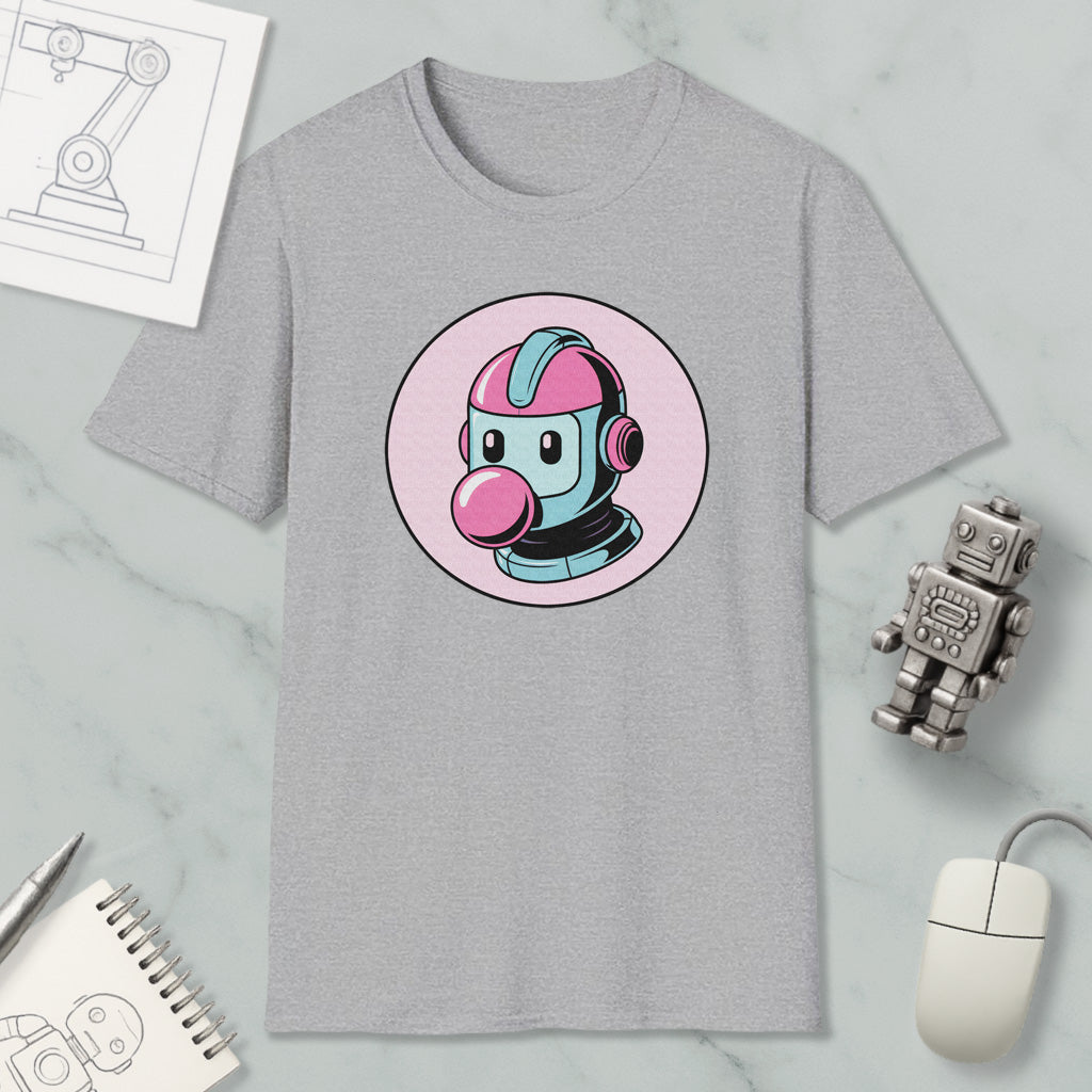 a gray t-shirt with a pink and blue robot head graphic, along with various objects such as a computer mouse, a notebook, and a robot figurine.