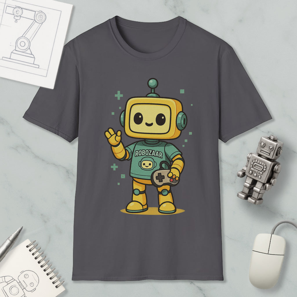 a gray t-shirt with a cartoon robot character wearing a green shirt and holding a game controller. The t-shirt is displayed on a marble surface, along with a computer mouse, a notebook, and a small robot figurine.