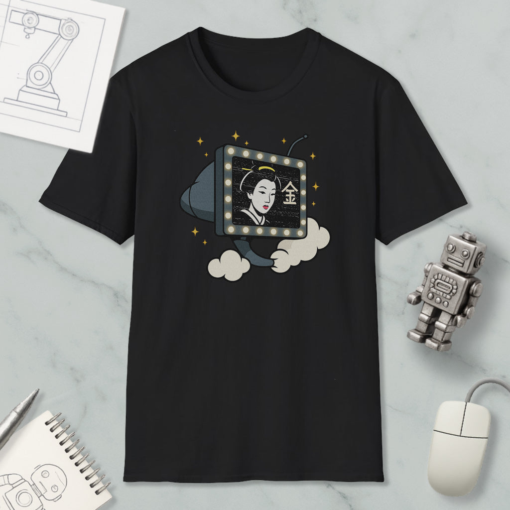 a black t-shirt with a graphic design depicting a woman's face inside a television set, surrounded by clouds and stars. The t-shirt is placed on a marble surface, with a computer mouse, a notebook, and a robot figurine nearby.