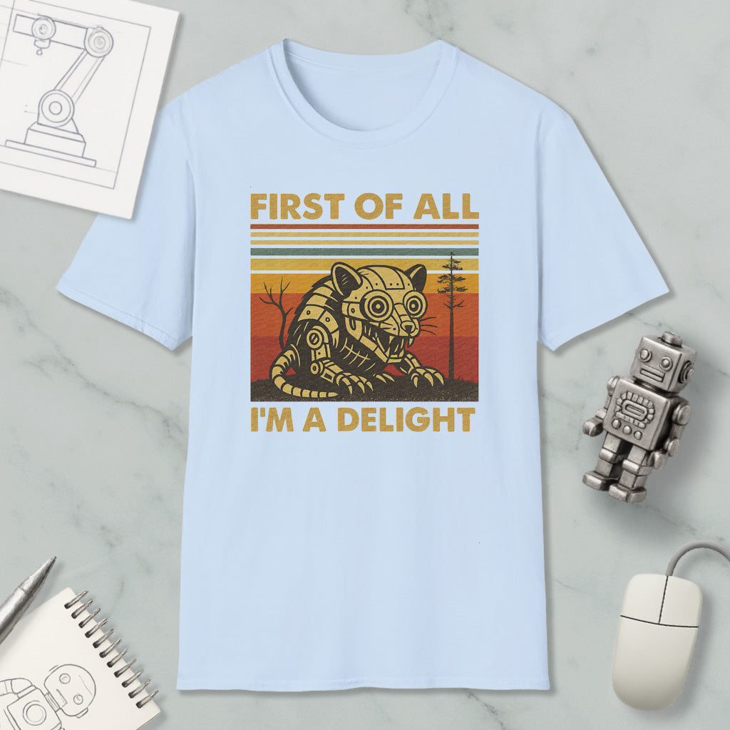 a light blue t-shirt with a graphic design of a robot or mechanical figure, along with the text "FIRST OF ALL I'M A DELIGHT". The t-shirt is displayed on a marble surface, and there are various objects such as a computer mouse, a pen, and a notebook nearby.