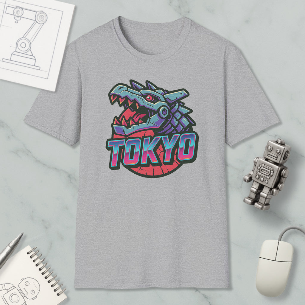 a gray t-shirt with a graphic design of a dragon head and the word "TOKYO" written on it, along with various objects such as a computer mouse, a notebook, and a robot.