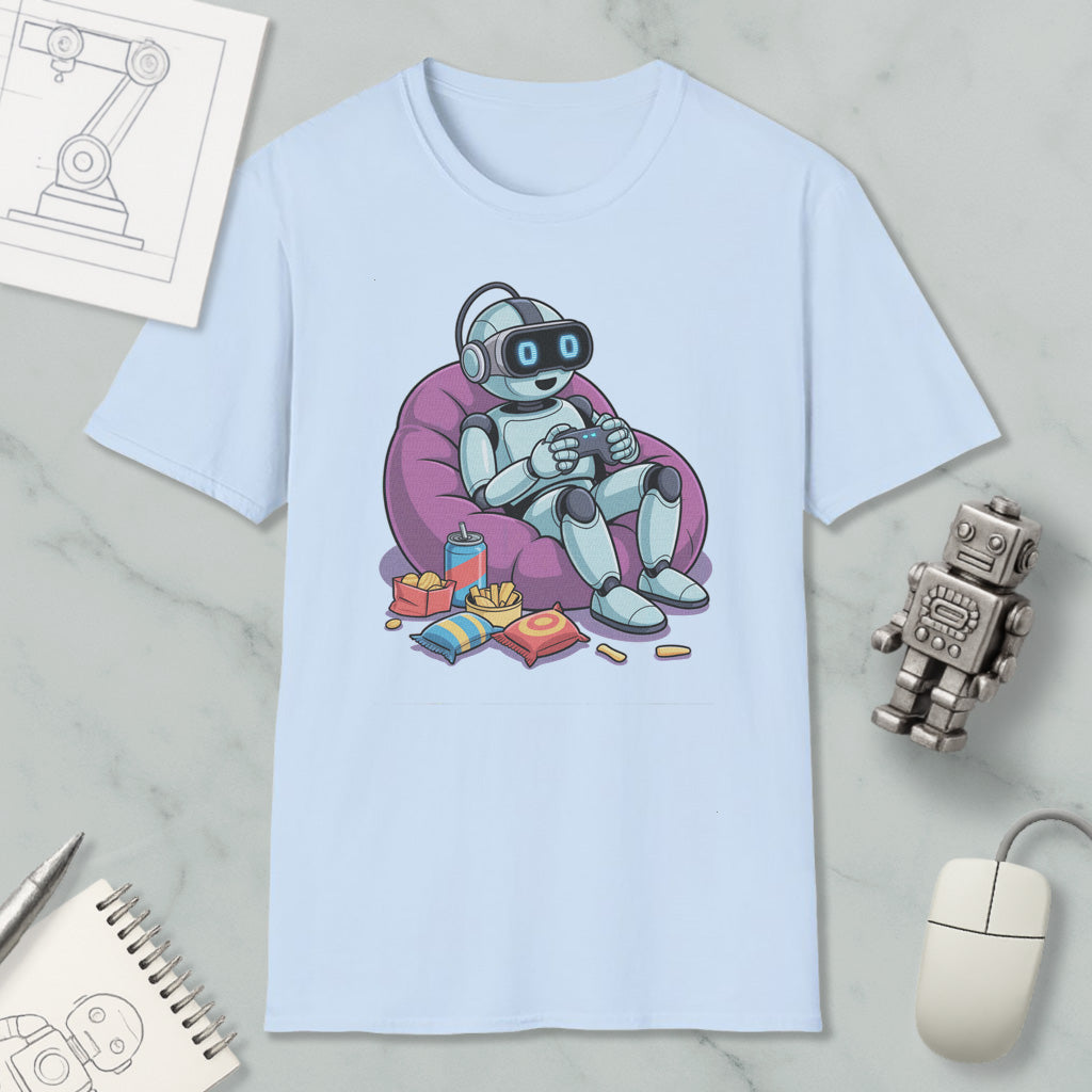 A light blue t-shirt with a cartoon robot sitting in a bean bag chair, holding a game controller, surrounded by snacks and a computer mouse.