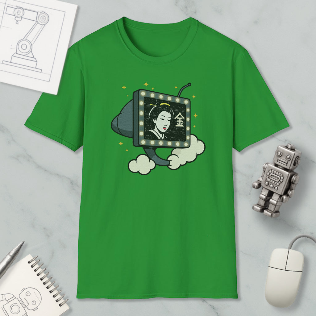 a green t-shirt with a graphic design depicting a woman's face on a television screen, surrounded by clouds and stars. The t-shirt is placed on a marble surface, with a computer mouse, a notebook, and a robot figurine nearby.