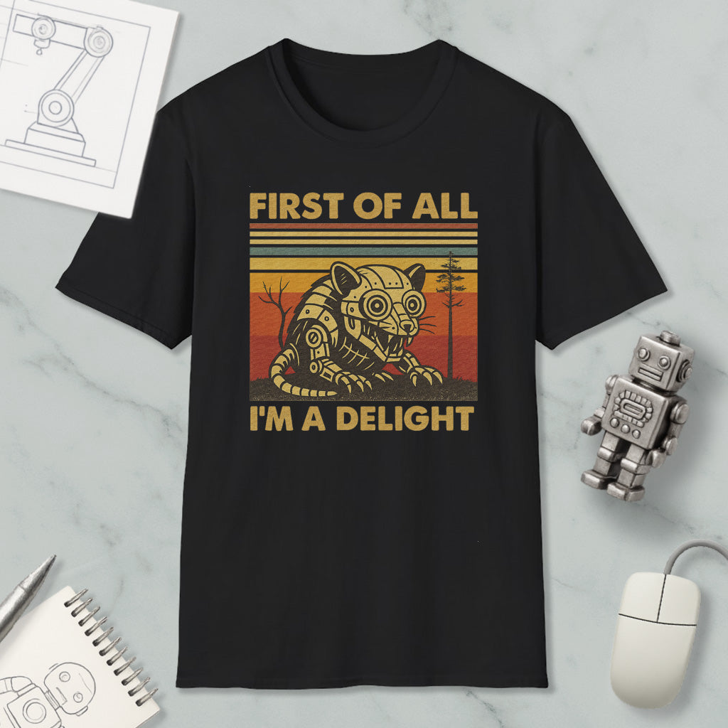 a black t-shirt with a graphic design depicting a robot or mechanical figure, accompanied by the text "FIRST OF ALL I'M A DELIGHT".