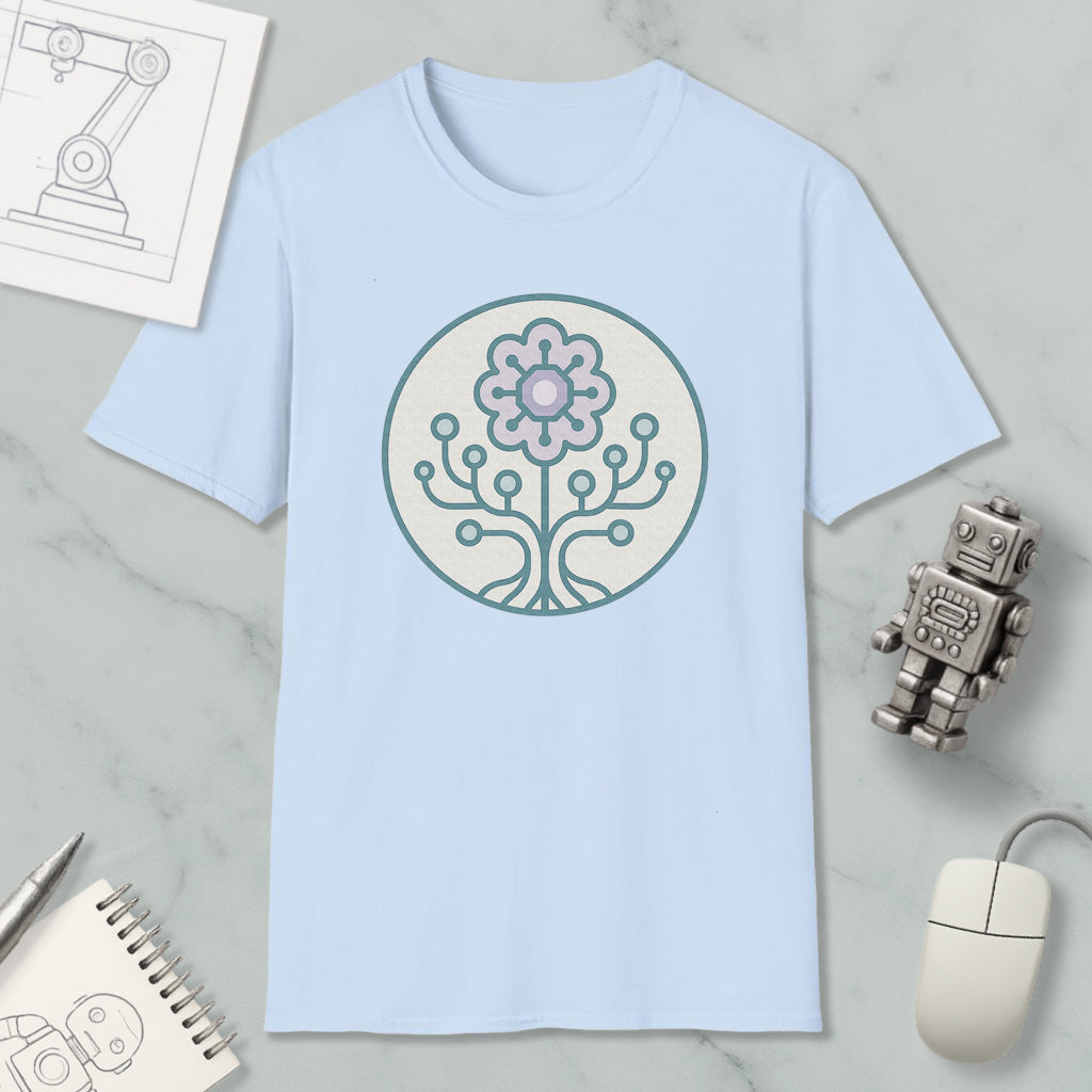 a light blue t-shirt with a circular design on it, surrounded by various objects such as a computer mouse, a robot, and a notebook.