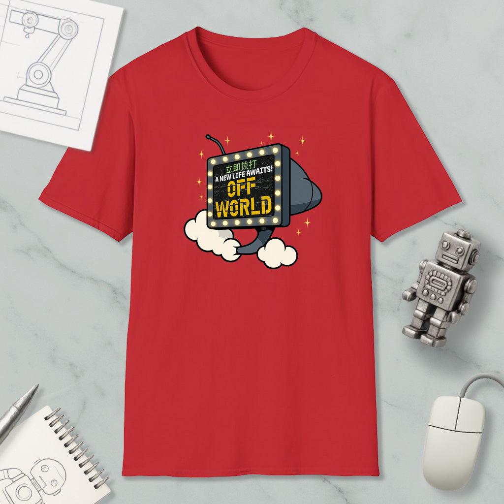 a red t-shirt with a graphic design, a computer mouse, a notebook, and a robot figurine on a marble surface.