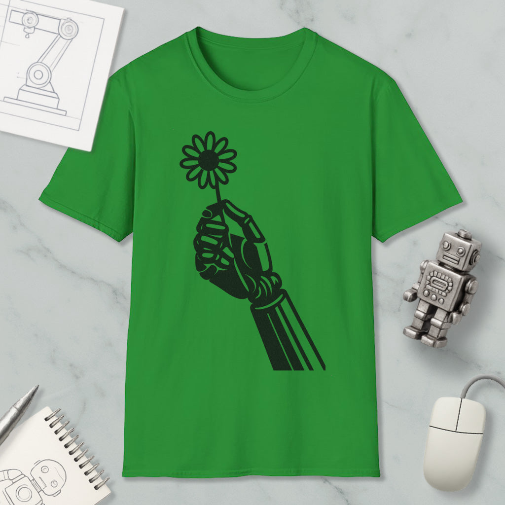 a green t-shirt with a black graphic design of a hand holding a flower, along with a computer mouse, a notebook, and a small robot figurine.