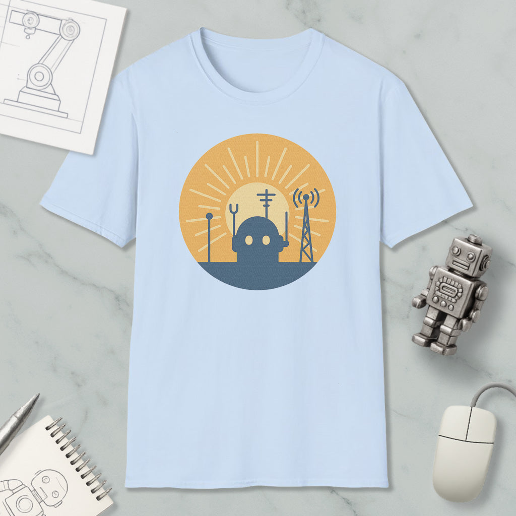 a light blue t-shirt with a graphic design depicting a robot and various technological elements, such as a tower and antenna, set against a sun-like background.