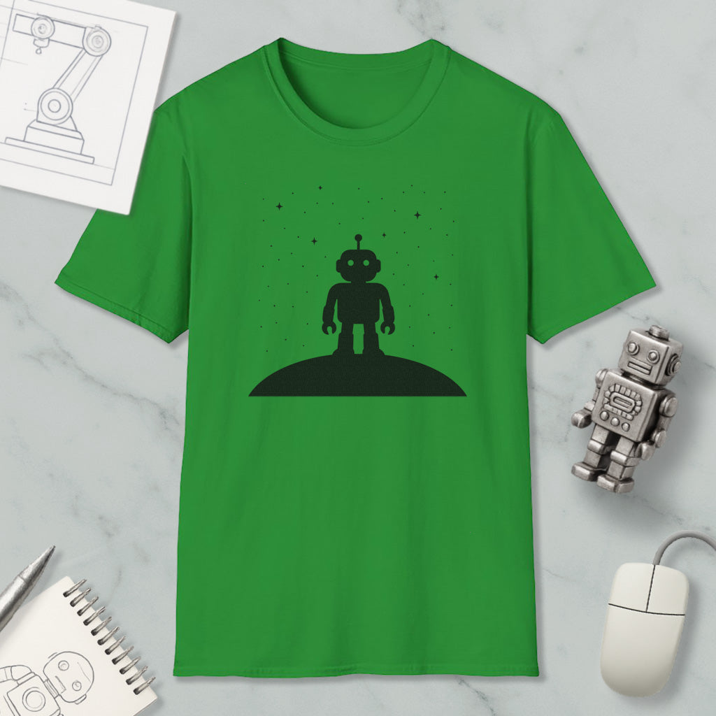 a green t-shirt with a black silhouette of a robot standing on a hill, along with various objects such as a computer mouse, a notebook, and a robot figurine.