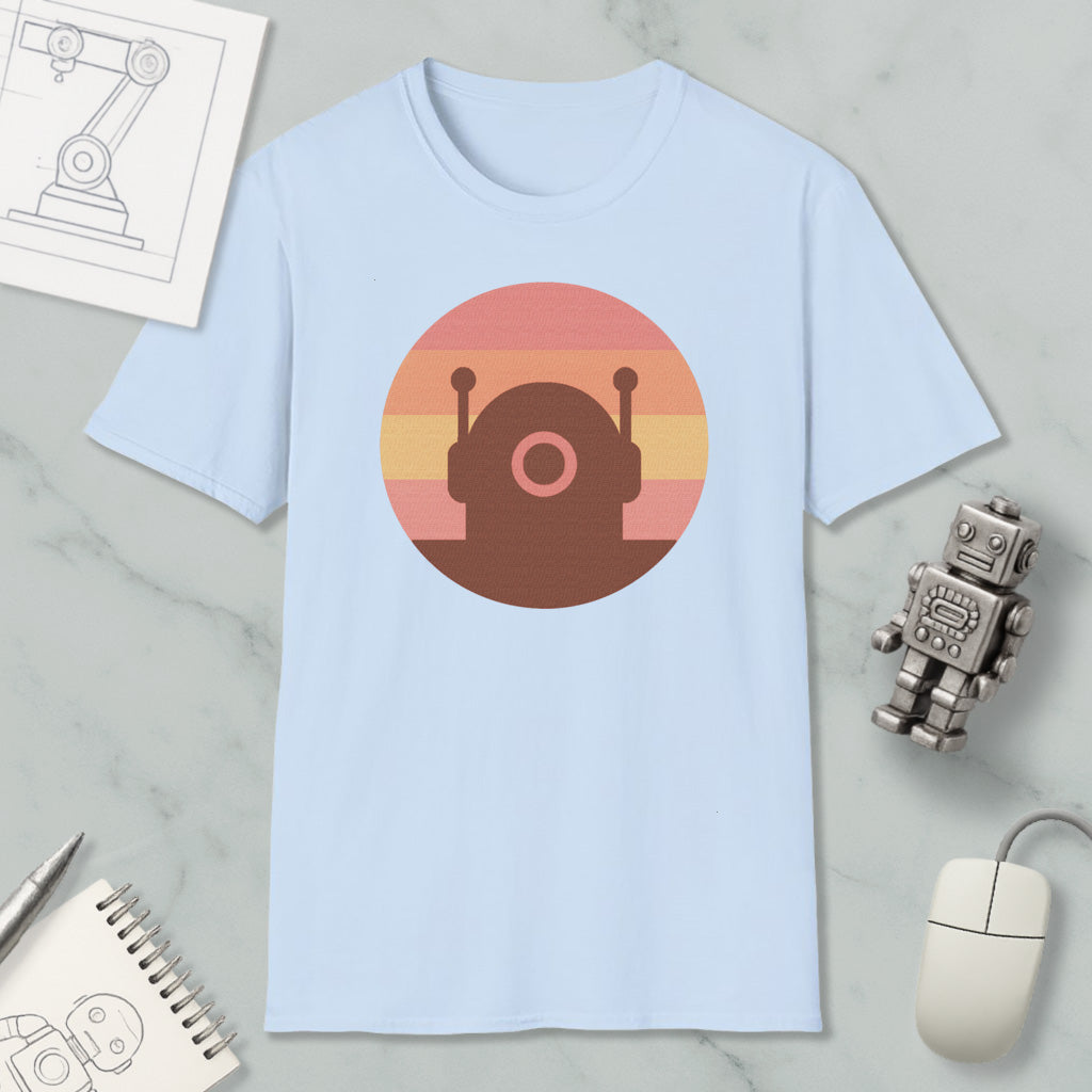 a light blue t-shirt with a circular graphic design, a small robot figurine, a computer mouse, and a notebook on a marble surface.
