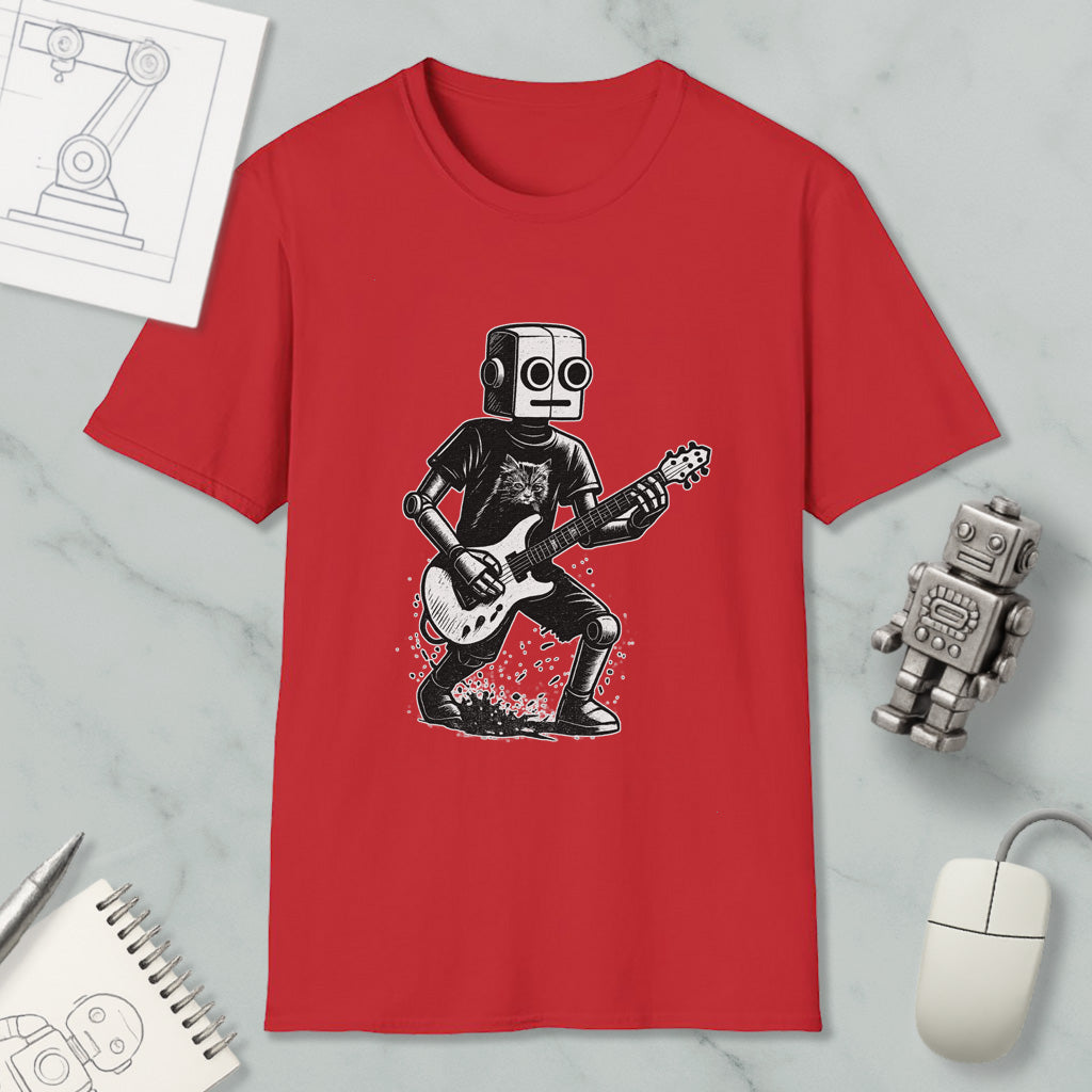 a red t-shirt with a graphic of a robot playing a guitar, along with a computer mouse, a notebook, and a robot figurine.