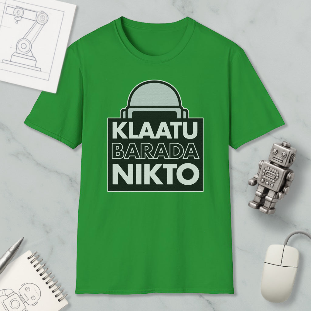 a green t-shirt with a graphic design, a computer mouse, a notebook, and a small robot figurine.