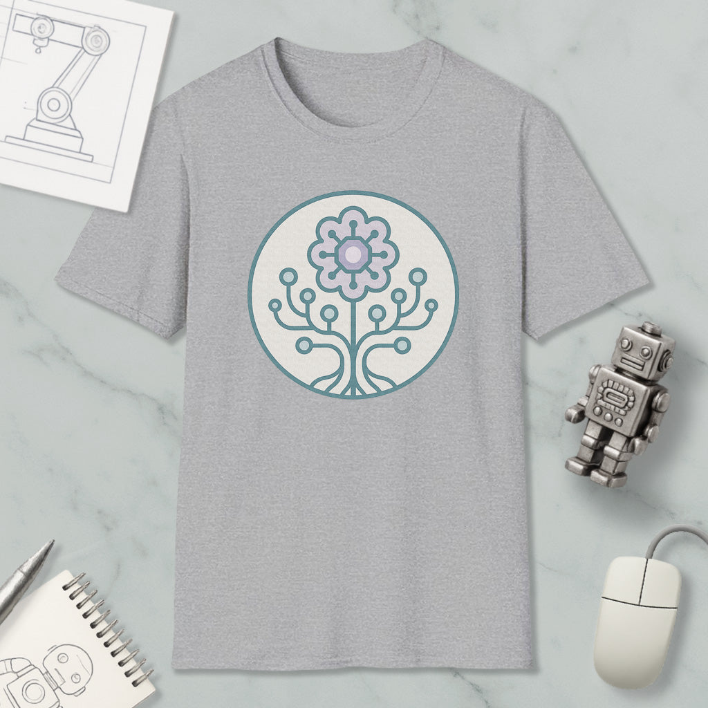 a gray t-shirt with a circular design on it, surrounded by various objects such as a computer mouse, a robot, and a notebook.